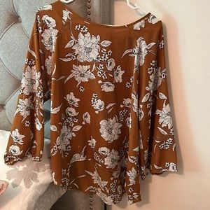 Great top for the office or dressy casual.  Hangs lower in back.